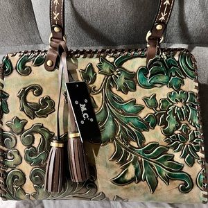 What a Wonderful Tan and Green Leather Embossed M.C. Satchel